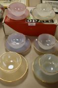 A boxed set of vintage French Arc Opal harlequin tea cup and saucers