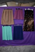 Five mixed vintage skirts including 1960s floral velvet maxi skirt and 1950s pencil skirt.