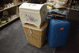 A selection of storage containers including painted bedding box and wicker laundry