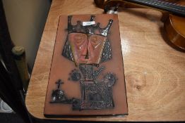 A ceramic mid century wall tile with Nordic Viking style imagery