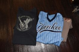 A selection of various music related t shirts in a range of sizes