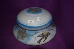 A vintage fly catcher light shade painted with birds and foliage