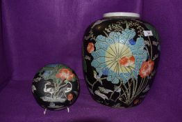 A substantial Chinese export hard paste ginger jar having famille noir ground dcorated with king