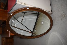 An early 20th Century oak oval wall mirror, approx. 92 x 67cm