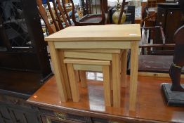 A modern golden oak effect nest of three occasional tables