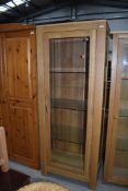 A modern golden oak glazed display cabinet, approx. W69cm D44cm H179cm