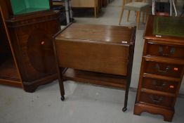 A traditional mahogany tea trolley, approx 66 x 41cm, with deep flaps and undershelf