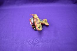 A 1930's Klimax Series tinplate and clockwork Stunt Flyer Aeroplane with Pilot, in yellow and red