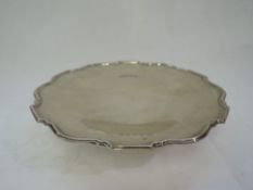 A silver footed salver of plain shaped form having moulded rim, Birmingham 1931, Barker Brothers