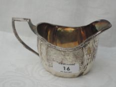 A silver cream jug of plain canted form having engraved decoration to rim and base, Sheffield