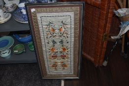 A Framed oriental embroidery using colourful threads, possibly silk or silk blend having a floral