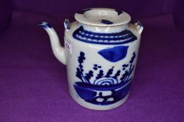 A Chinese export hard paste tea pot with blue and white decoration