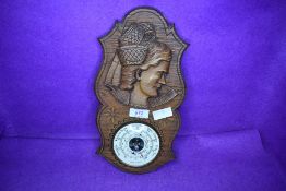 An oak carved barometer with a German design