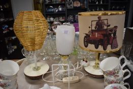 Three vintage lamps, one having quirky motor car scene to shade.
