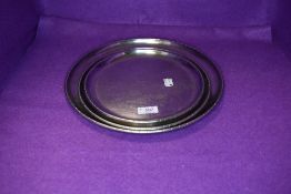 A selection of three Arts and Crafts graduated dishes of circular form by Keswick school of