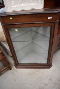 An Edwardian mahogany corner wall display having glass shelves
