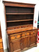 An 19th Century part oak and cross banded dresser , plate racking having three drawers to base, over