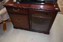A mahogany effect hifi cabinet, labelled J E Coyle