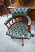 A reproduction button back green leather office chair