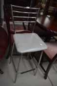 A vintage style chrome frame kitchen bar stool with vinyl seat