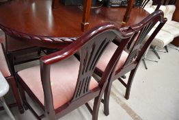 A reproduction Regency style dining table and set of six (four plus two) dining chairs