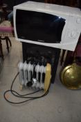 A Dimplex woodburner effect electric fire, a Samsung Microwave and small oil filled radiator