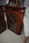 A late Victorian/Edwardian mahogany corner wall display cabinet having astral glazed door