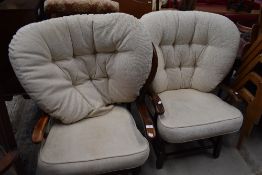 A pair of traditional stained frame upholstered cottage style armchairs