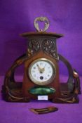 And unusual carved wood arts and crafts clock having ceramic detail to underneath face, in need of