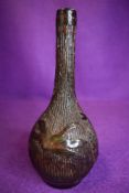 A posy vase having naturalistic scene of insects in shellac/tortoiseshell or similar applied to