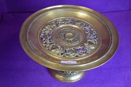 A antique brass tazza or similar having crown and maidens in side profile to top.