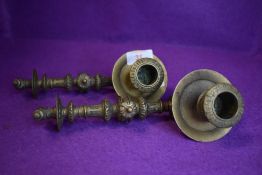 A pair of ornately decorated antique detachable carriage candle sticks