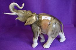 A Royal Dux elephant having pink triangular lozenge to underside.