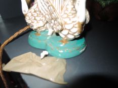 An antique royal Worcester desk top lamp having figural swan decoration to base with gilt