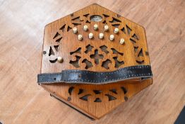 A traditional 21 button concertina, labelled Lachenal, 62872 early 20th Century, in wooden case