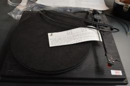 A late 1980s Revolver turntable, belt driven finished in black ash veneer, with accompanying