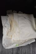 A small collection of vintage table linen including deep crotchet edged and embroidered examples.