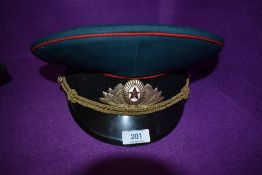 A military officers style cap having Russian cap badge and label dated 1991