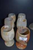 Six Onyx or similar goblets, one with repair.