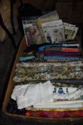 A box full of vintage and retro dress patterns, fabric and similar.