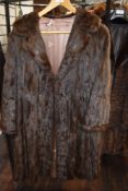 A vintage mid length brown fur coat.