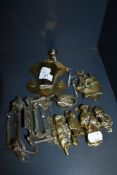 A collection of vintage brass door knockers and handles.