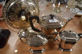 A folding cake stand and a plated tea set comprising of tea pot,sugar and creamer.