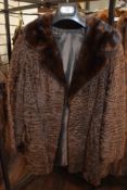 A vintage Swakara south west African Karakul Lamb coat in brown with mink collar.