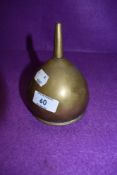 A brass funnel with integral filter.