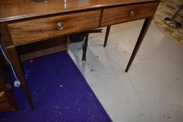 A 19th Century mahogany side table having Regency style ring handles to the two frieze drawers, on