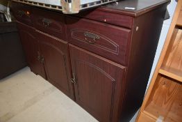 A modern laminate side board with three drawers and under cupboards