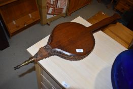 A set of traditional oak fire bellows having heart shaped handles, leather and studwork