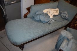 A 19th Century mahogany chaise longue having scroll frame on turned legs and heavy brass casters,