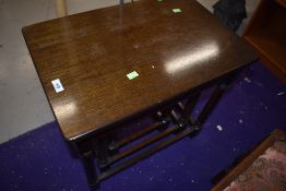 A reproduction oak nest of three tables in the traditional style, top table approx. 59cm width
